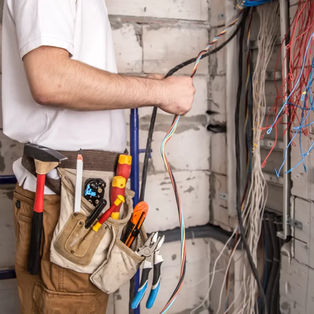a person holding a tool belt with wires