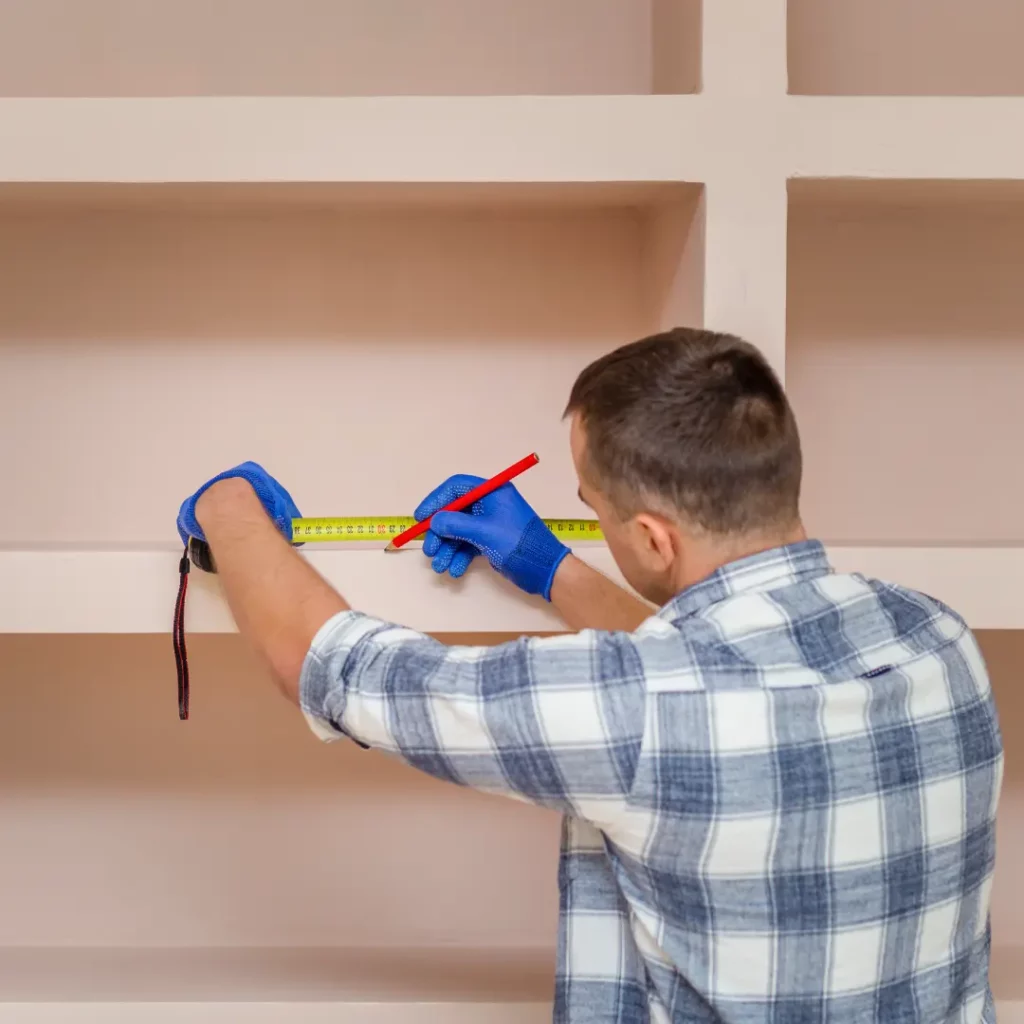 a person measuring a shelf