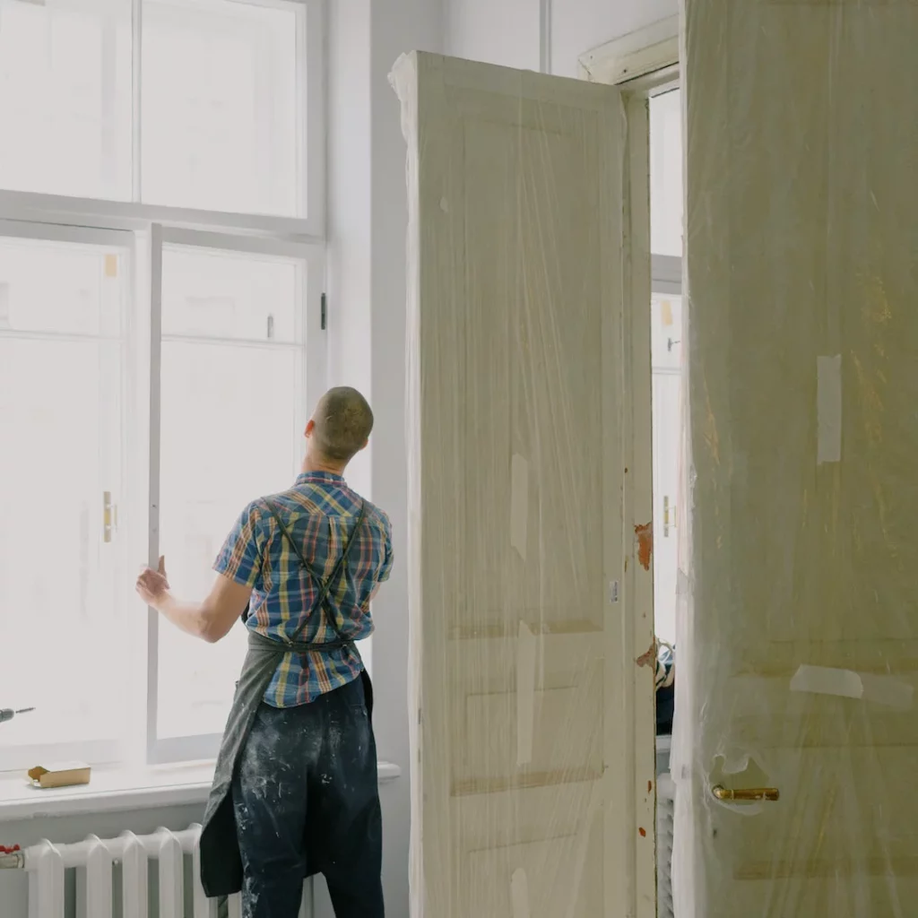a person in apron installing a door